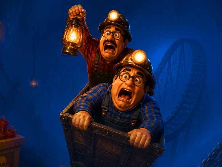 Two frightened miners in a wooden cart, lanterns lit, wearing helmets with headlamps and plaid shirts as they race through a blue cave-like background with a roller-coaster track nearby.